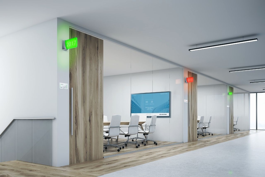 Modern office corridor showcases conference rooms with digital availability indicators, blending wooden accents with a minimalist design.