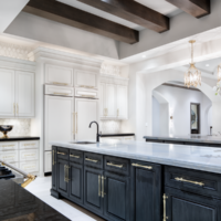 A large black and white kitchen with Lutron lighting.