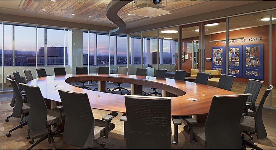 A modern Denver conference room featuring automated AV solutions with digital displays and video conferencing technology.